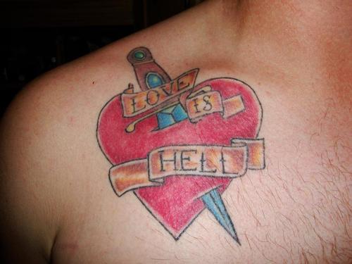 Heart and dagger tattoo on chest.