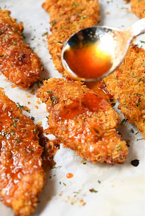 crispy baked hot honey chicken with sauce dripping on chicken