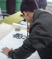 A student demonstrating calligraphy