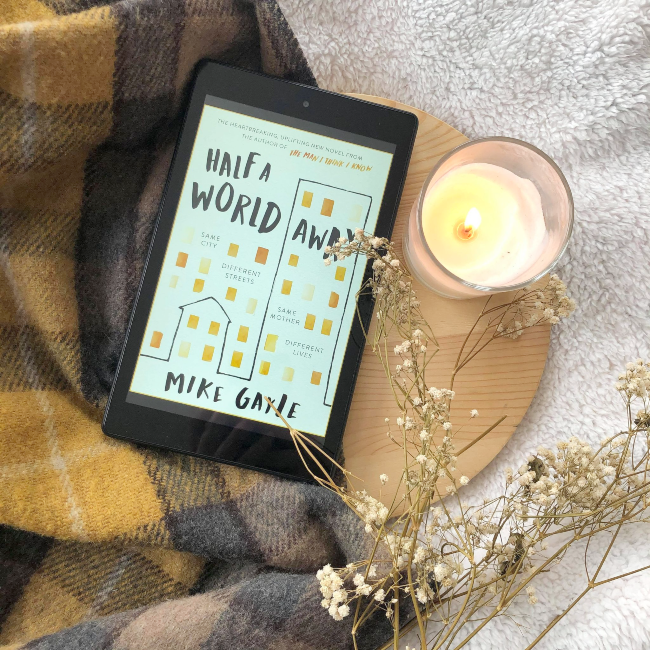 Cover of 'Half A World Away' by Mike Gayle next to a candle