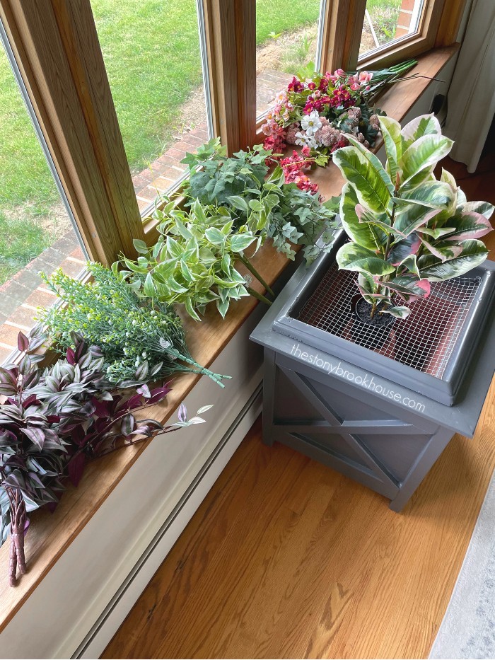 all different faux plants for the planter
