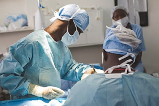 Doctors performing surgery on a patient