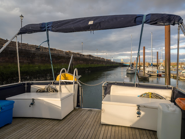 Photo of the bimini wrapped up in its newly repaired cover