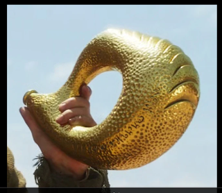 Wheel of Time show's Horn of Valere, it's a gold lump with a scaled pattern on the outside.