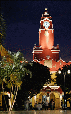 Merida clock tower on main square at Night with park in front