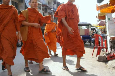 Image of young Buddhist monks walking to school at the start of the day in Phnom Penh, Cambodia.