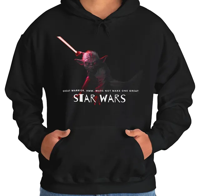 A Hoodie With Star Wars Yoda Having Reddish Light On Body Holding Blade and Caption Great Warrior.. Wars Not Make One Great