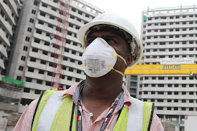 In a photo taken on June 24, 2013, a worker wears a N95 mask while working at a construction site as protection against the haze.