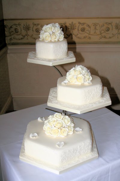 Each tier is completed with a handcrafted Wedding Cake topper of diamante 