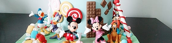 Header picture of candy land cake with mickey, frozen and hello kitty