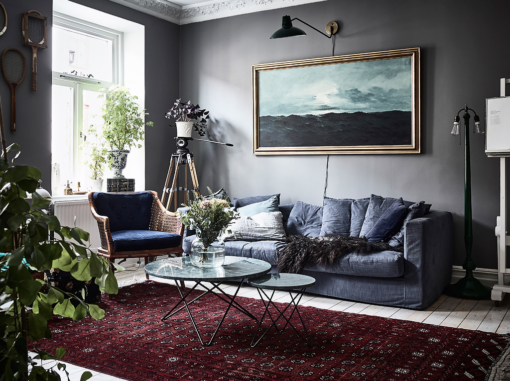 bohemian artist home scandinavian apartment  with houseplants wall art fireplace blue walls