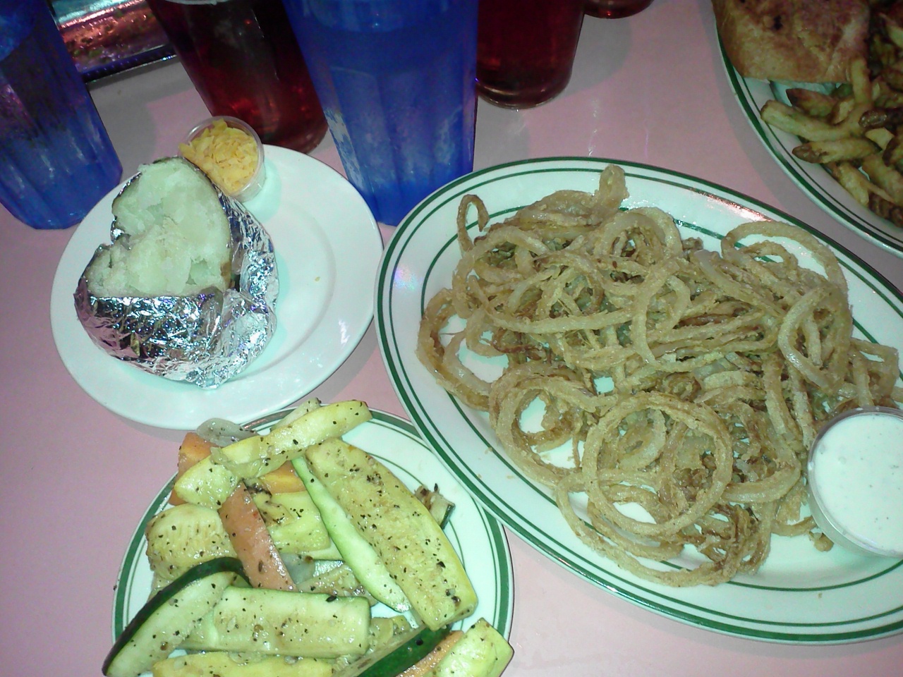 Nate's baked potato, veggies, and onion rings