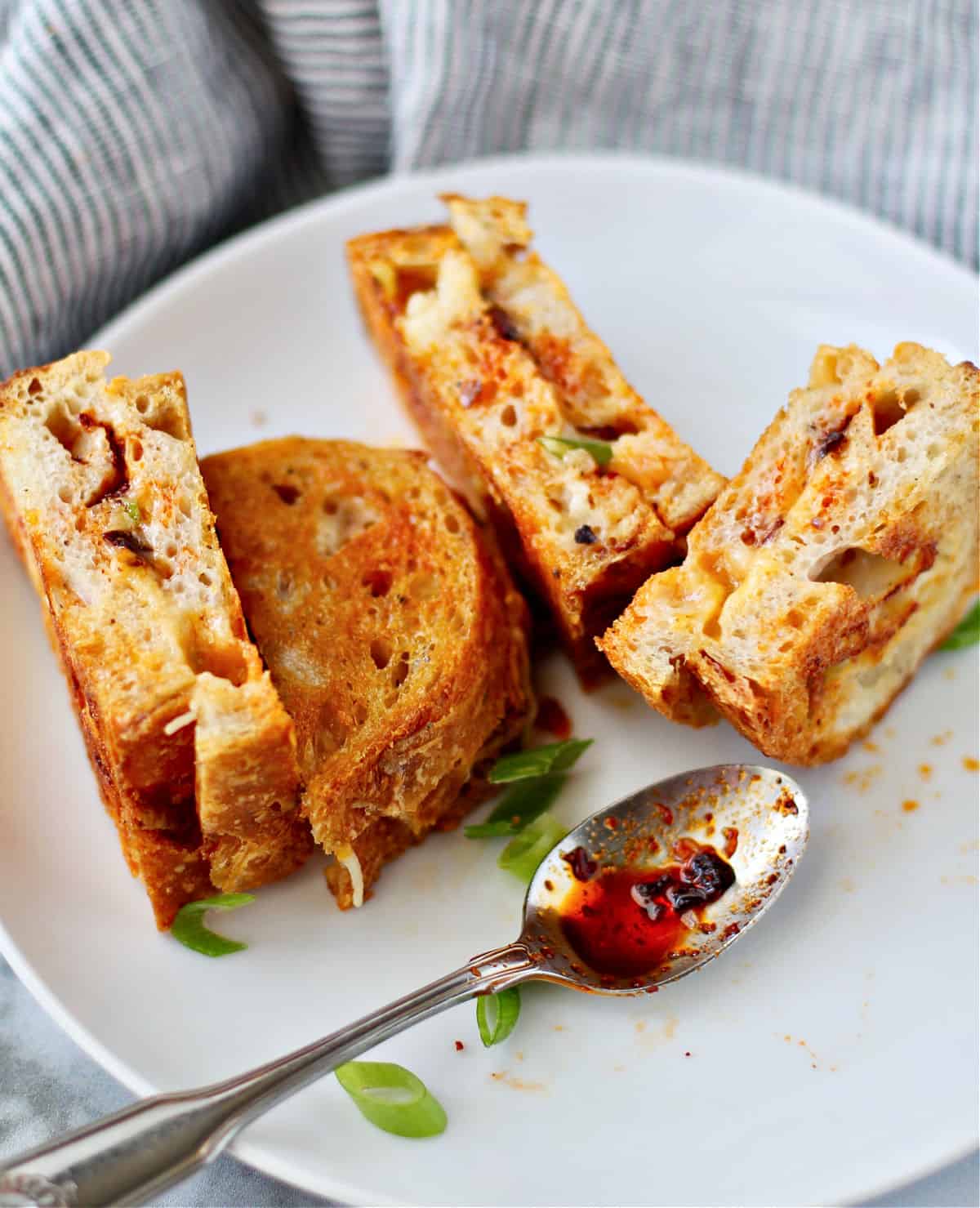 Chili crisp grilled cheese slices on a plate.