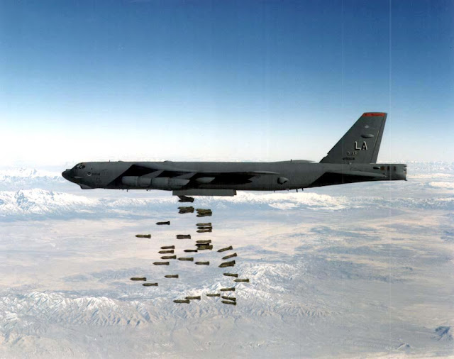 A B-52H Stratofortress drops a load of M-117 750-pound bombs.