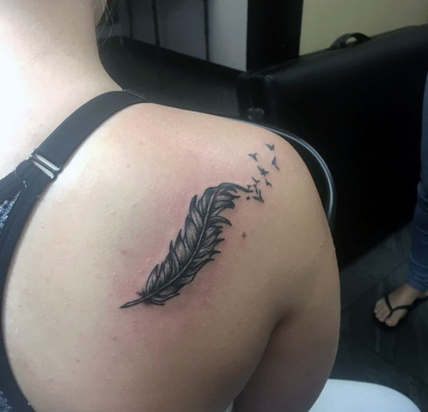 That is so cool and pretty feather tattoo with flying birds black and grey work tattoo design on girl right back shoulder