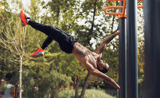 Fit man perform a human flag outdoor training