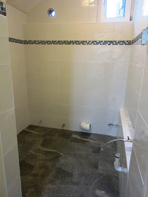 White tiled walls and grey tiled floor