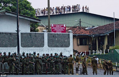 Rioting inmates on the roof of Colombo's Welikoda prison