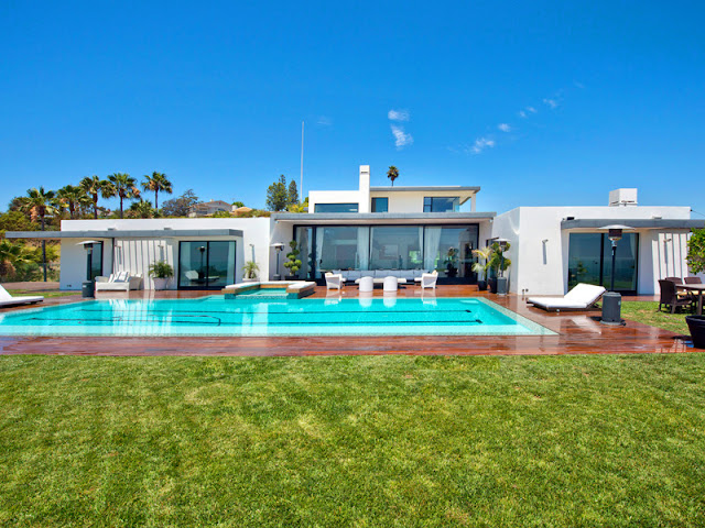 Photo of amazing bel air modern residence with the pool as seen from the lawn in the backyard