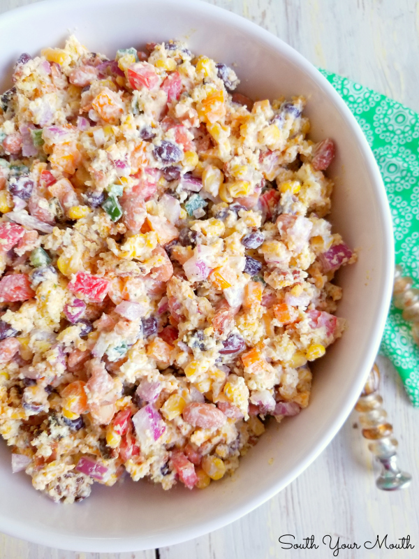 Confetti Cornbread Salad! A kaleidoscope of crisp bacon and diced fresh vegetables, creamy beans and shredded cheese tossed with sour cream dressing and crumbled cornbread in a bright, beautiful, fun salad perfect for potlucks, picnics and Sunday dinner.