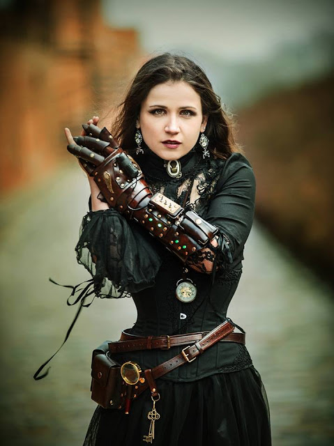 Steamgoth woman wearing gothic steampunk clothing with a leather gauntlet