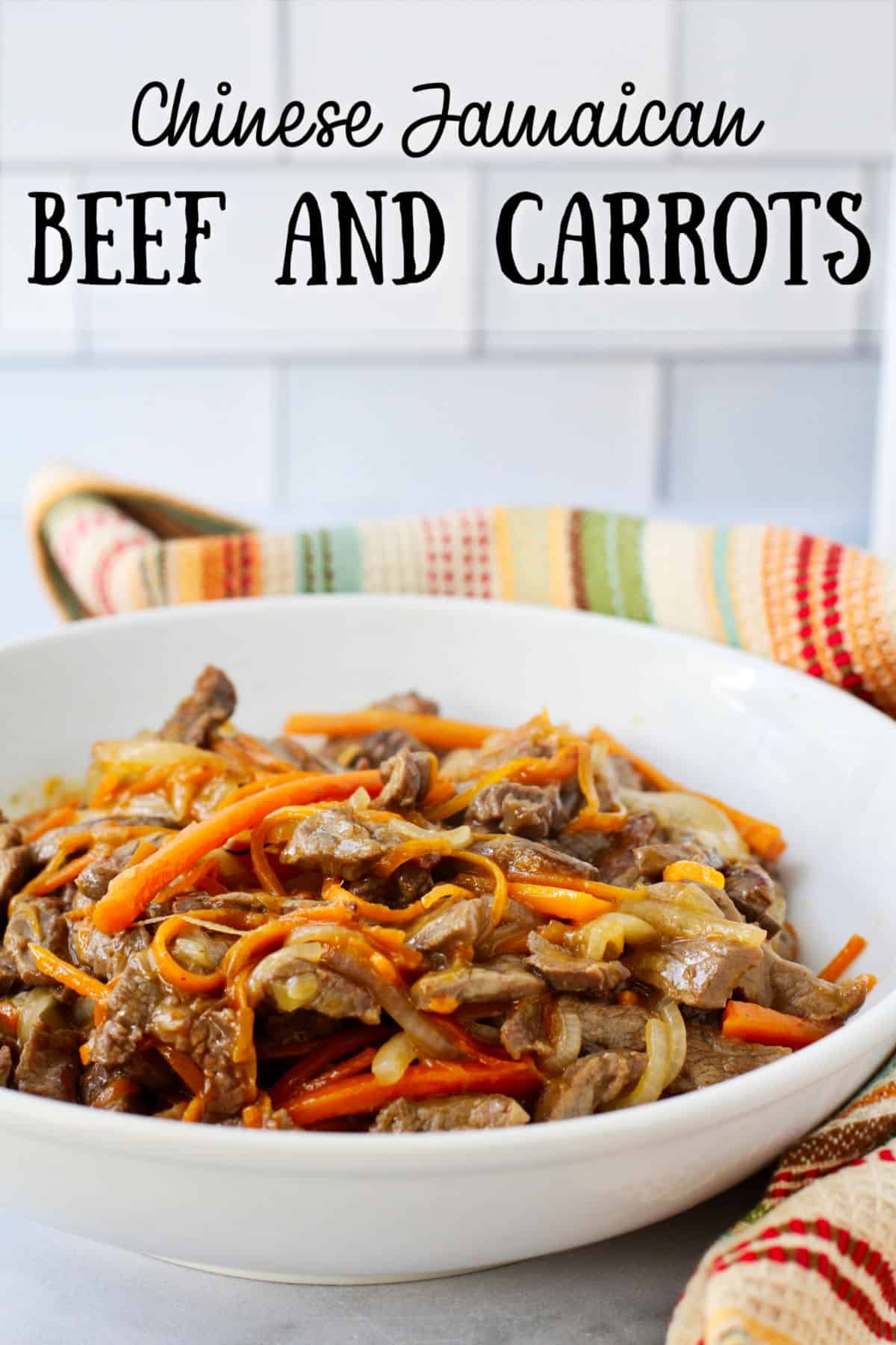 Chinese Jamaican Stir-Fried Beef and Carrots in a white bowl.