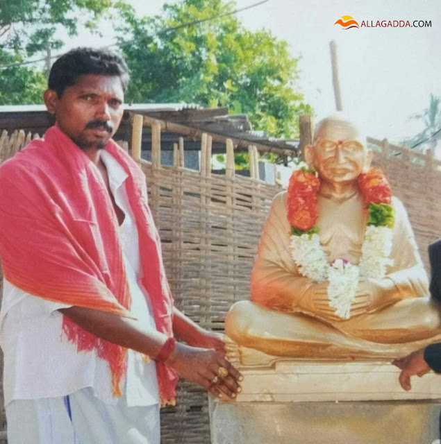 Veeraiah Achari Pulukuri.owner of the shop with gandhi statue