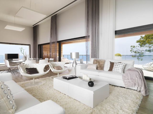 Open living room with large windows and white furniture and carpet