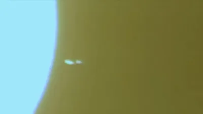 Huge silver UFO is entering the Sun and it passes all the way through it and comes out the other side of the Sun.