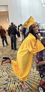 High school graduate and Serenity Fields in a yellow graduation gown and cap.