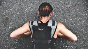 A woman doing a push-up that is a great strength training exercise for women that builds more than one muscle.