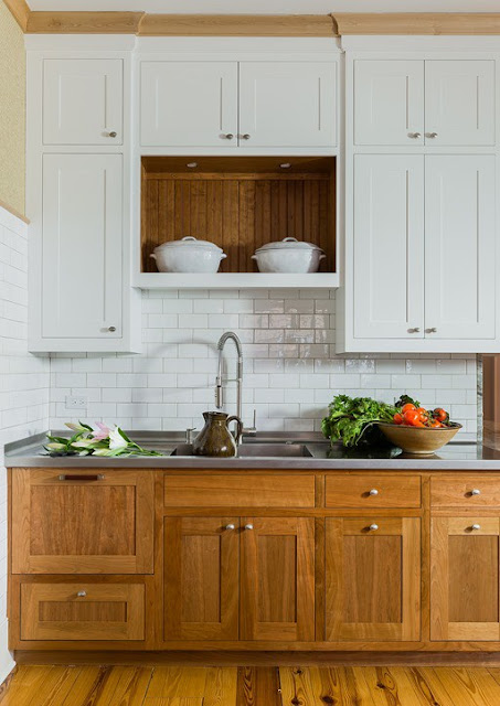 Modern farmhouse kitchen with stained wood base cabinets and white uppers found on Hello Lovely