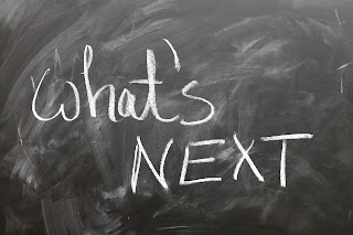 A blackboard with the words "what's next" written on it in chalk