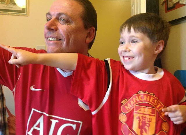 Man and Boy in Matching Football Shirts