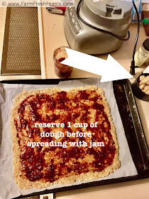 image of making raspberry coconut oatmeal bars--remember to reserve 1 cup of dough before patting the rest onto the baking sheet