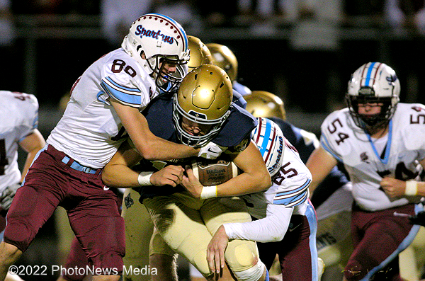 Colin Wayland and Aiden McCorkle bring down Central Catholic's ball carrier.