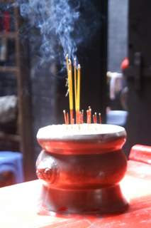 Image of burning incense in an incense burner at a shrine