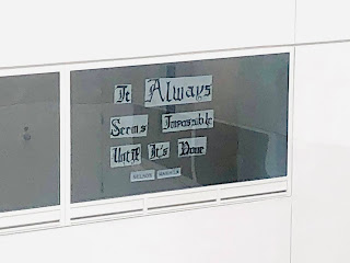 A hospital window that says, "It always seems impossible until it's done."