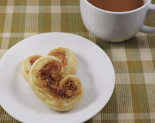 pastry on white plate with cup of coffee