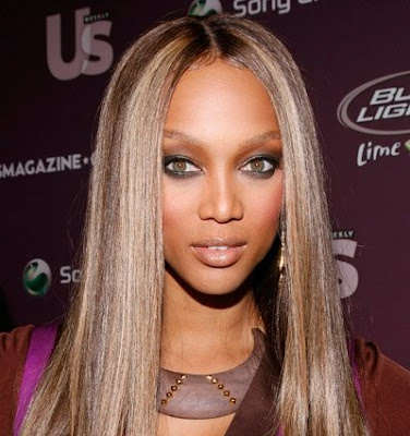 Tyra Banks with sophisticated multi-layered bun updos.