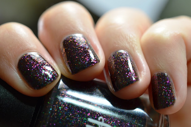 black nail polish with multichrome flakes and holo