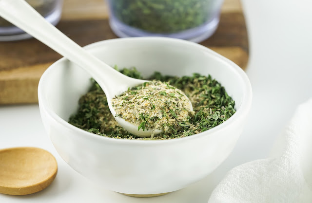 a white spoon of spaghetti seasoning sitting in a white bowl.