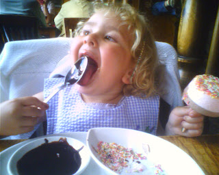 Top Ender licking the once filled with chocolate spoon