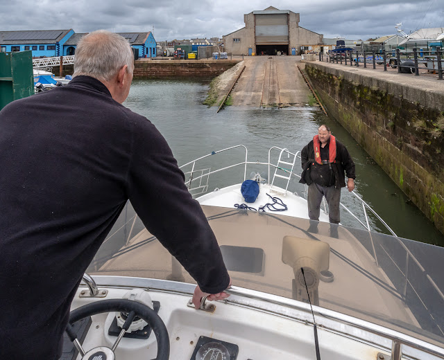 PHoto of Phil manoeuvering Ravensdale into the hoist