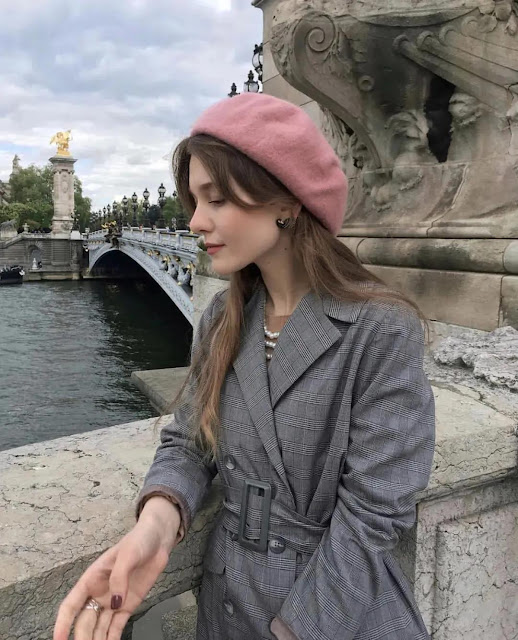 A woman wears a beret.