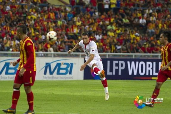 Sevilla player Piotr Trochowski shoots to score a goal against Selangor