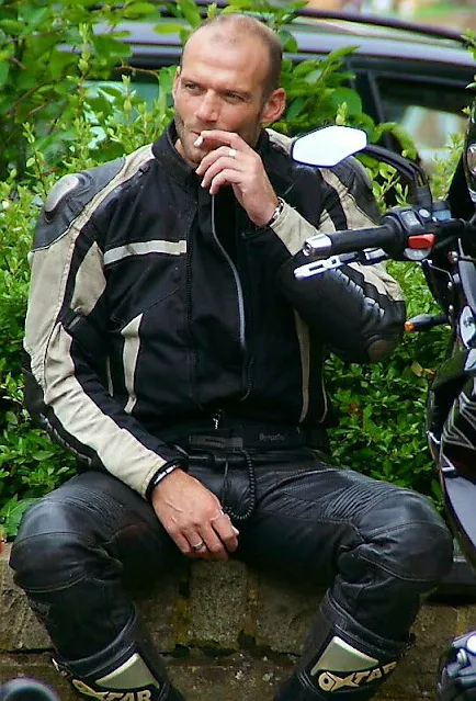 3/5 Leather Bikers Wearing Leathersuit Smoking A Cigarette