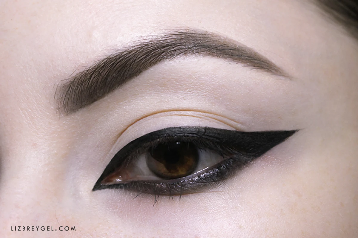 a close-up of an opened woman's eye with a thick arabic eyeliner look