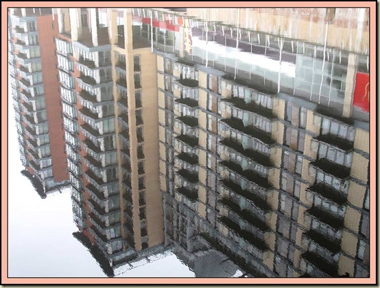 Reflections from tower blocks across the Irwell in Manchester