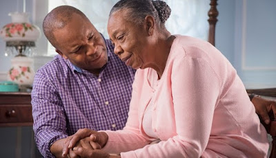family caregiver talks to elderly woman